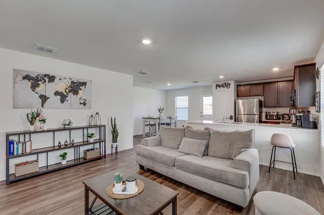 a view of a living room kitchen and a wooden floor