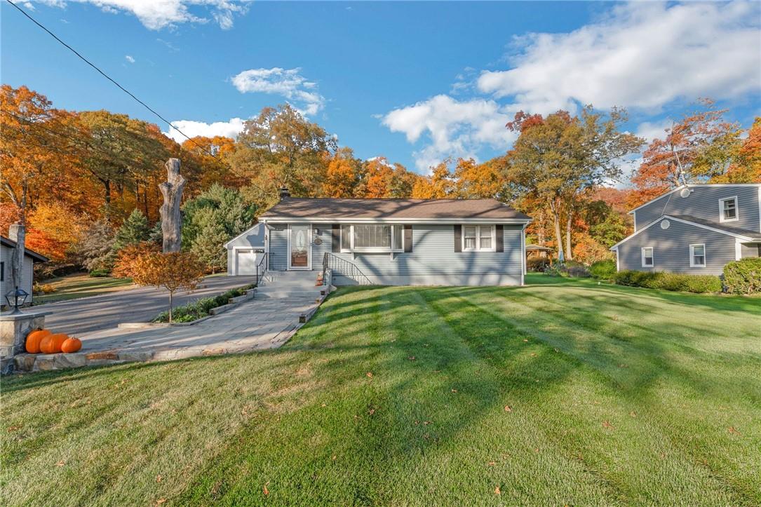 View of front of house featuring a front lawn and a garage