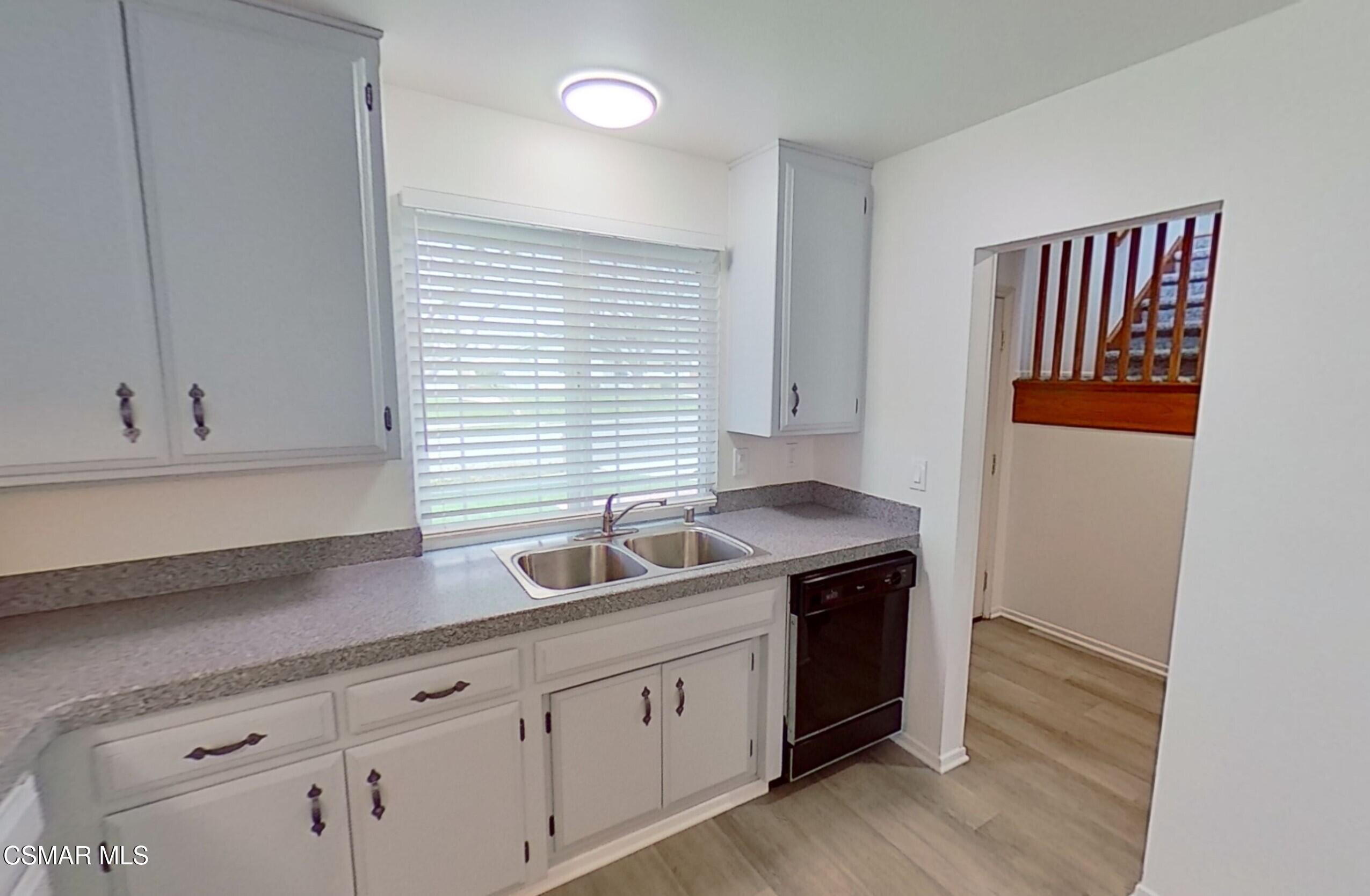 577 Appleton Road Simi Valley, CA 93065 - Photo 12 of 31 a kitchen with granite countertop white cabinets and sink