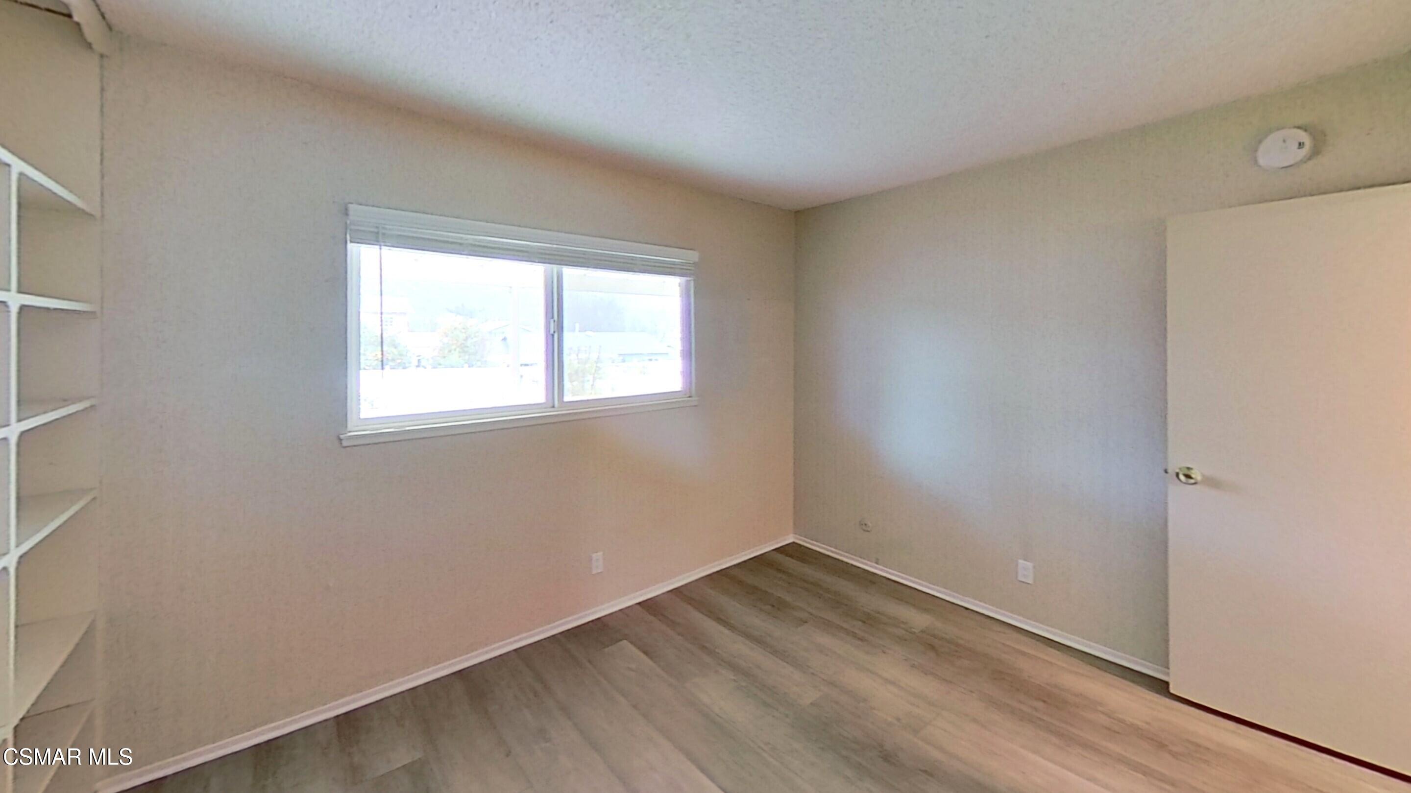 577 Appleton Road Simi Valley, CA 93065 - Photo 15 of 31 an empty room with wooden floor and windows