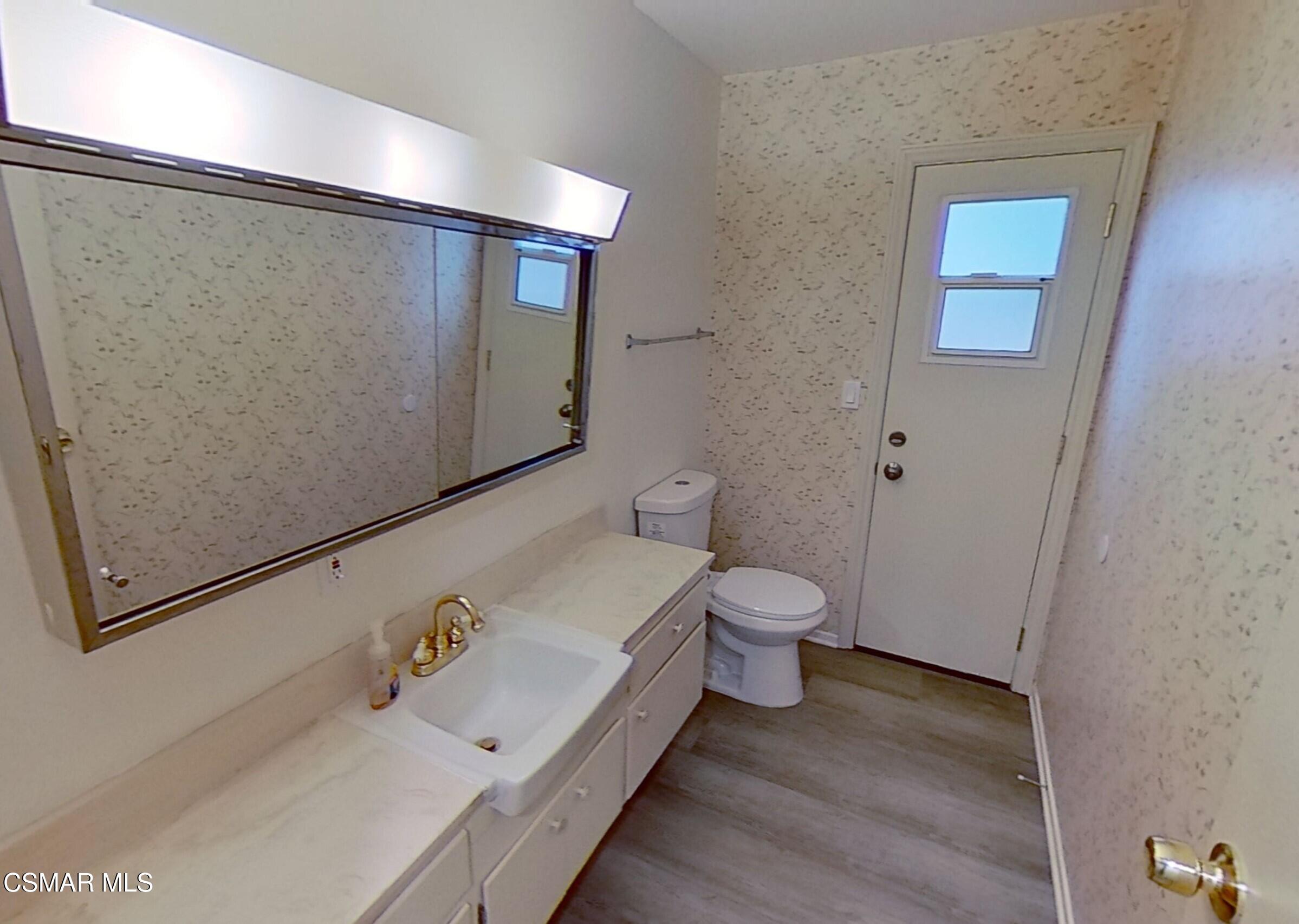 577 Appleton Road Simi Valley, CA 93065 - Photo 17 of 31 a white toilet sitting next to a bathroom sink