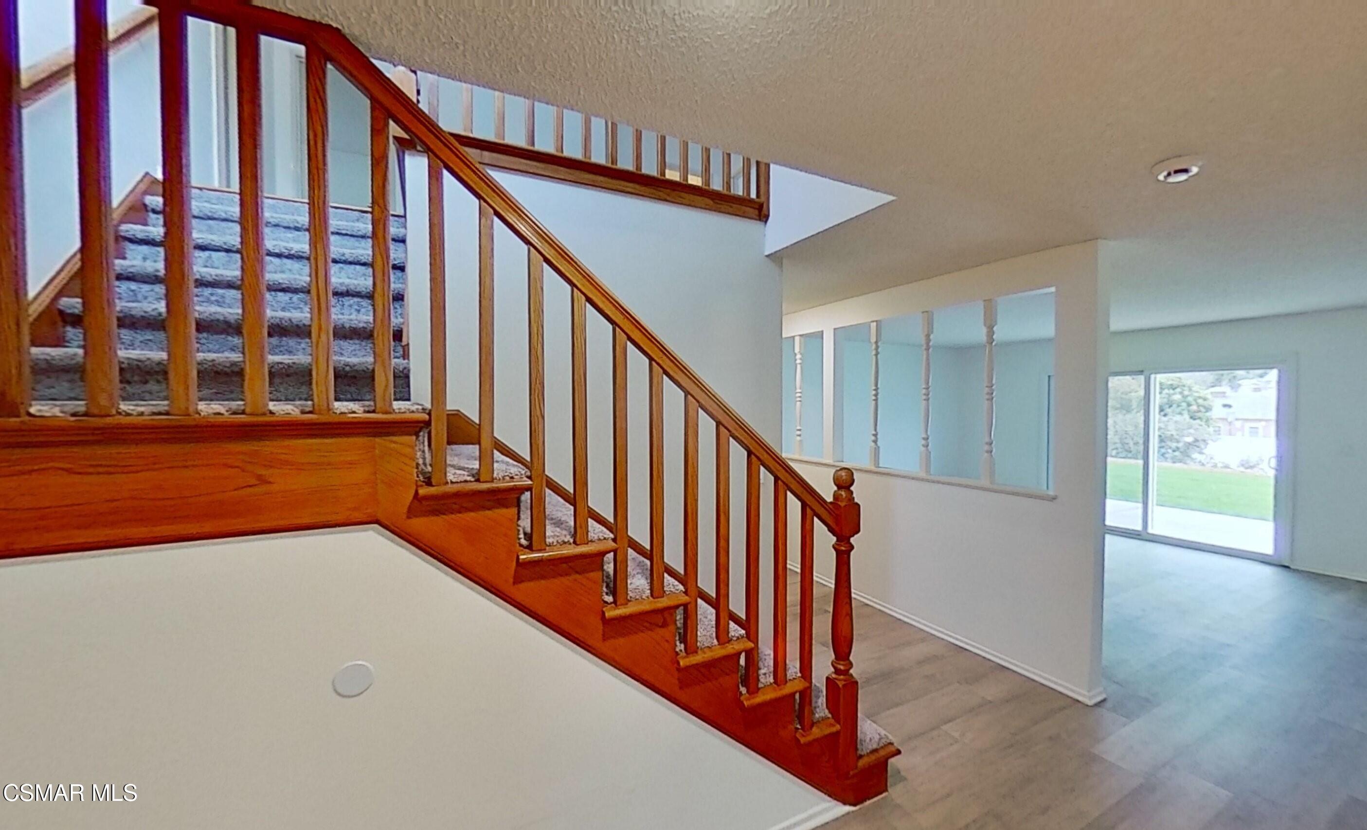 577 Appleton Road Simi Valley, CA 93065 - Photo 18 of 31 a view of staircase with lots of frames on wall and a window