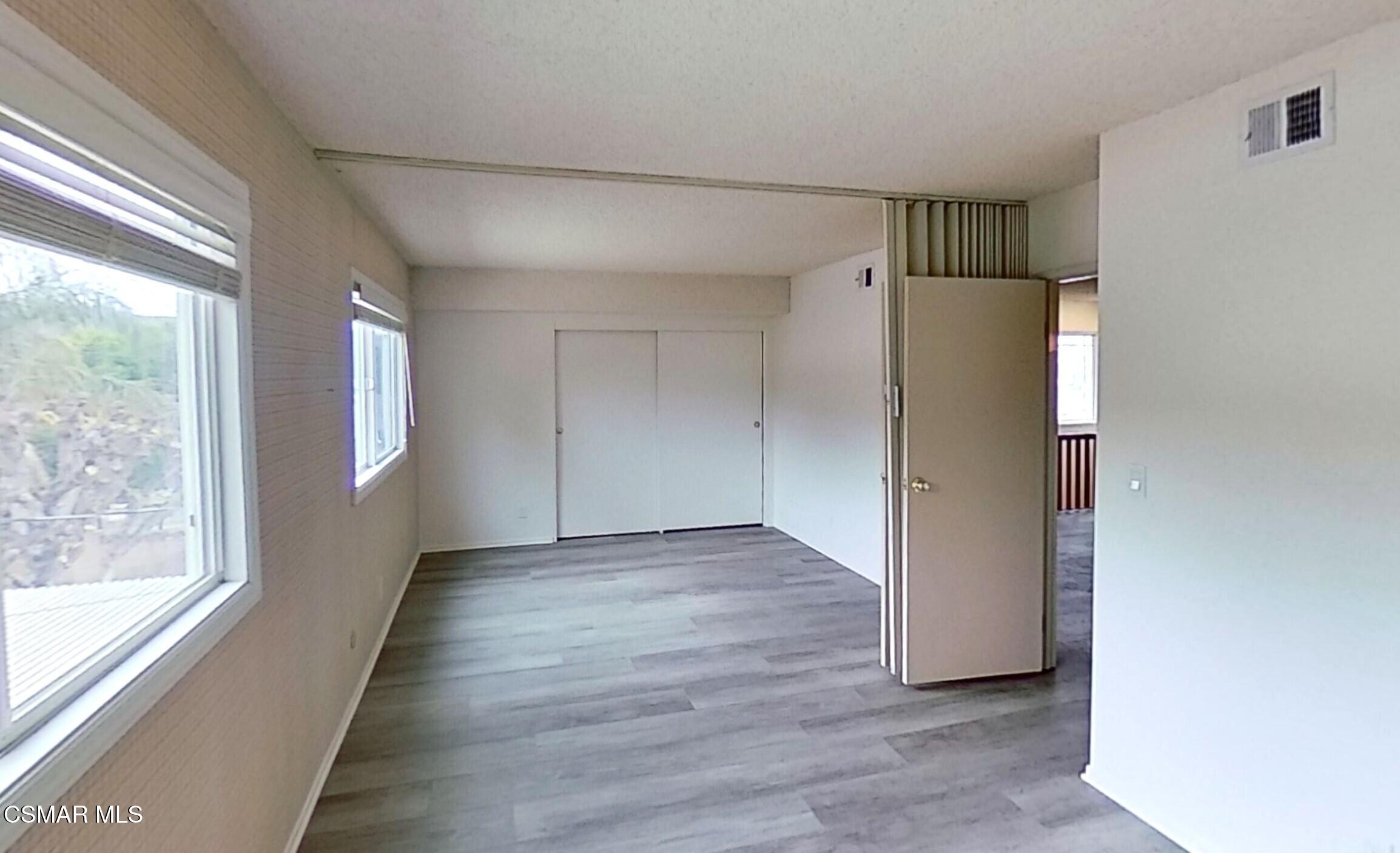 577 Appleton Road Simi Valley, CA 93065 - Photo 22 of 31 a view of an empty room with wooden floor and a window
