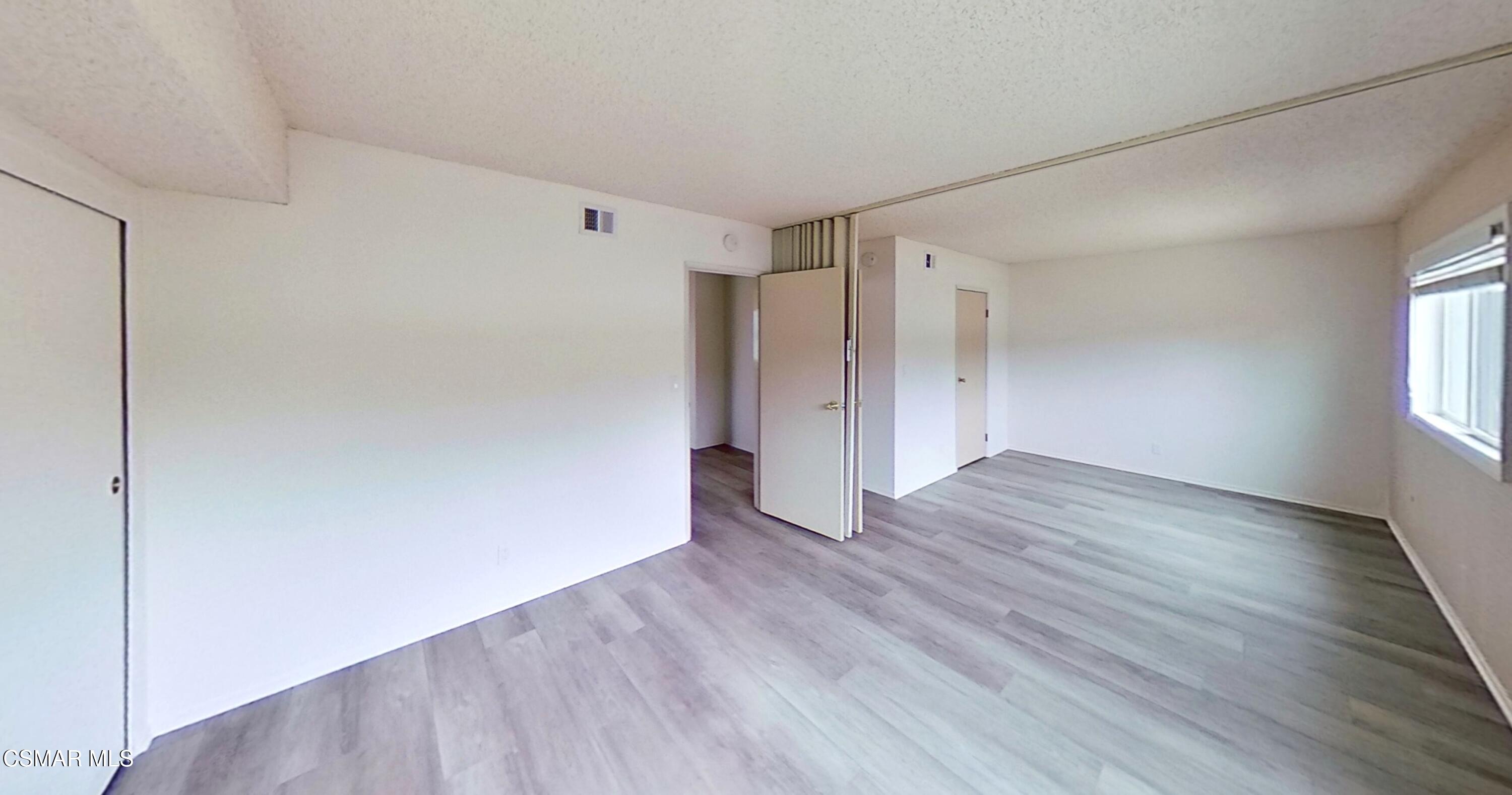 577 Appleton Road Simi Valley, CA 93065 - Photo 23 of 31 a view of an empty room with wooden floor and window