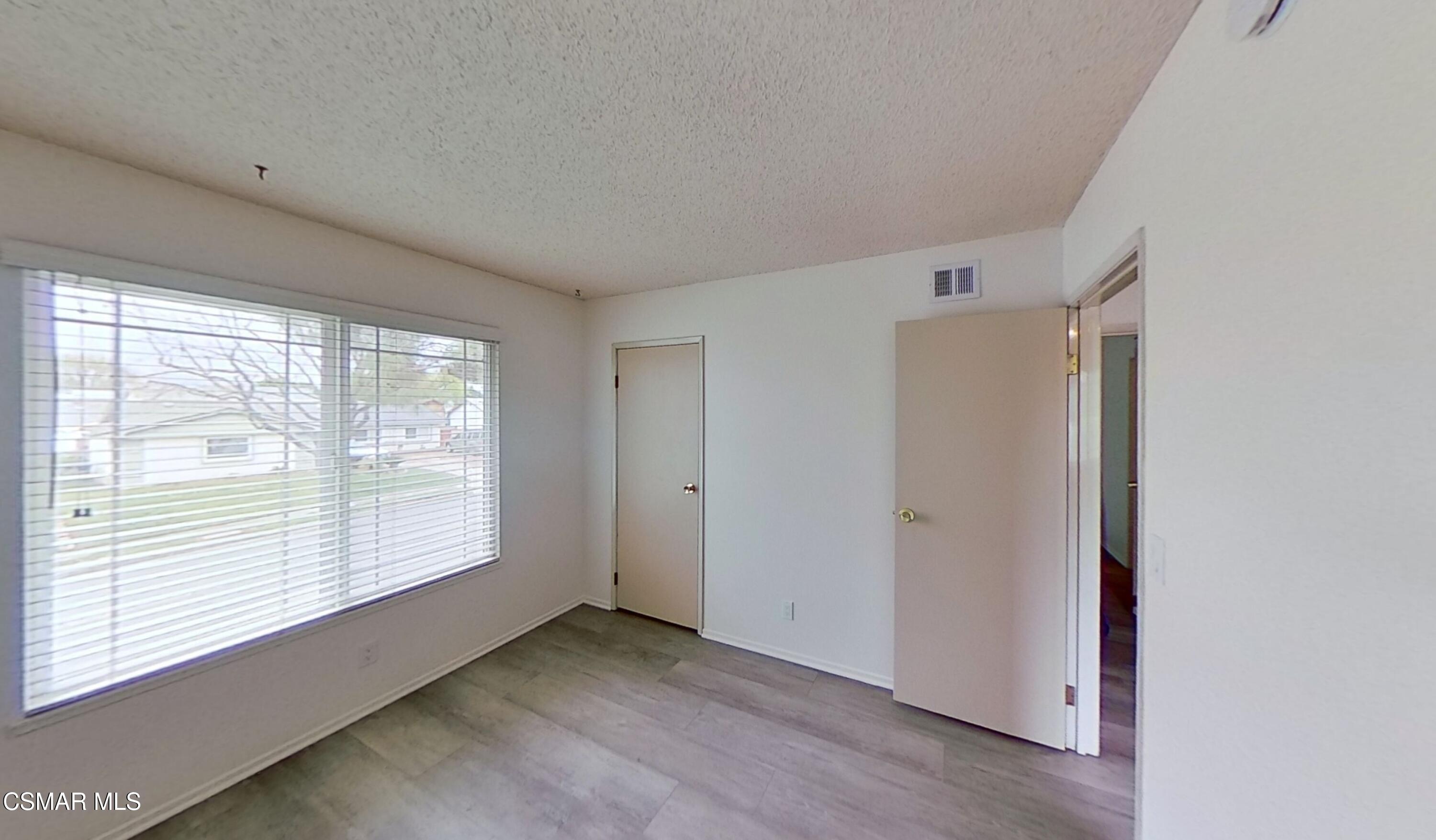 577 Appleton Road Simi Valley, CA 93065 - Photo 25 of 31 a view of an empty room with wooden floor and a window