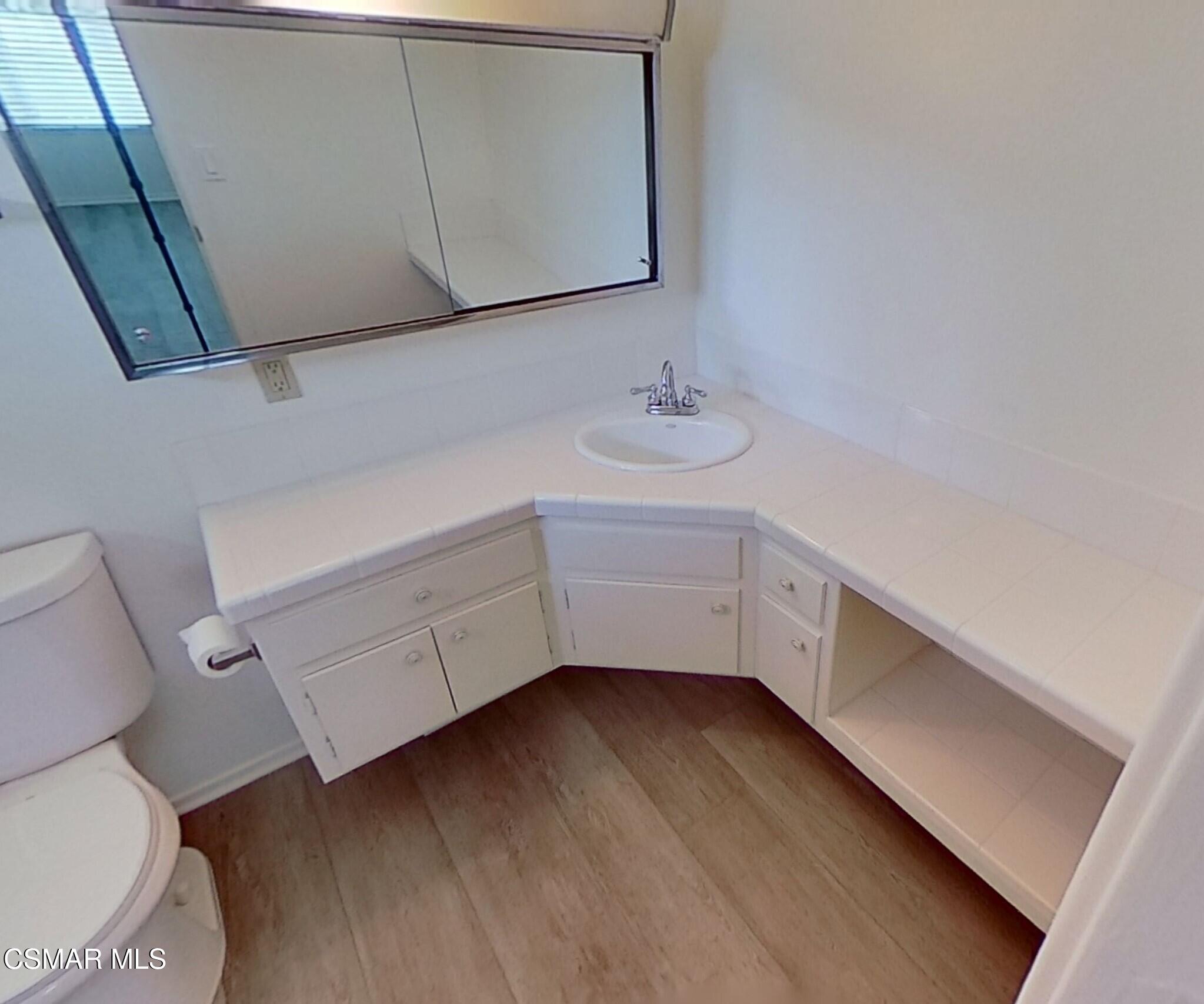577 Appleton Road Simi Valley, CA 93065 - Photo 27 of 31 a bathroom with a sink toilet and vanity