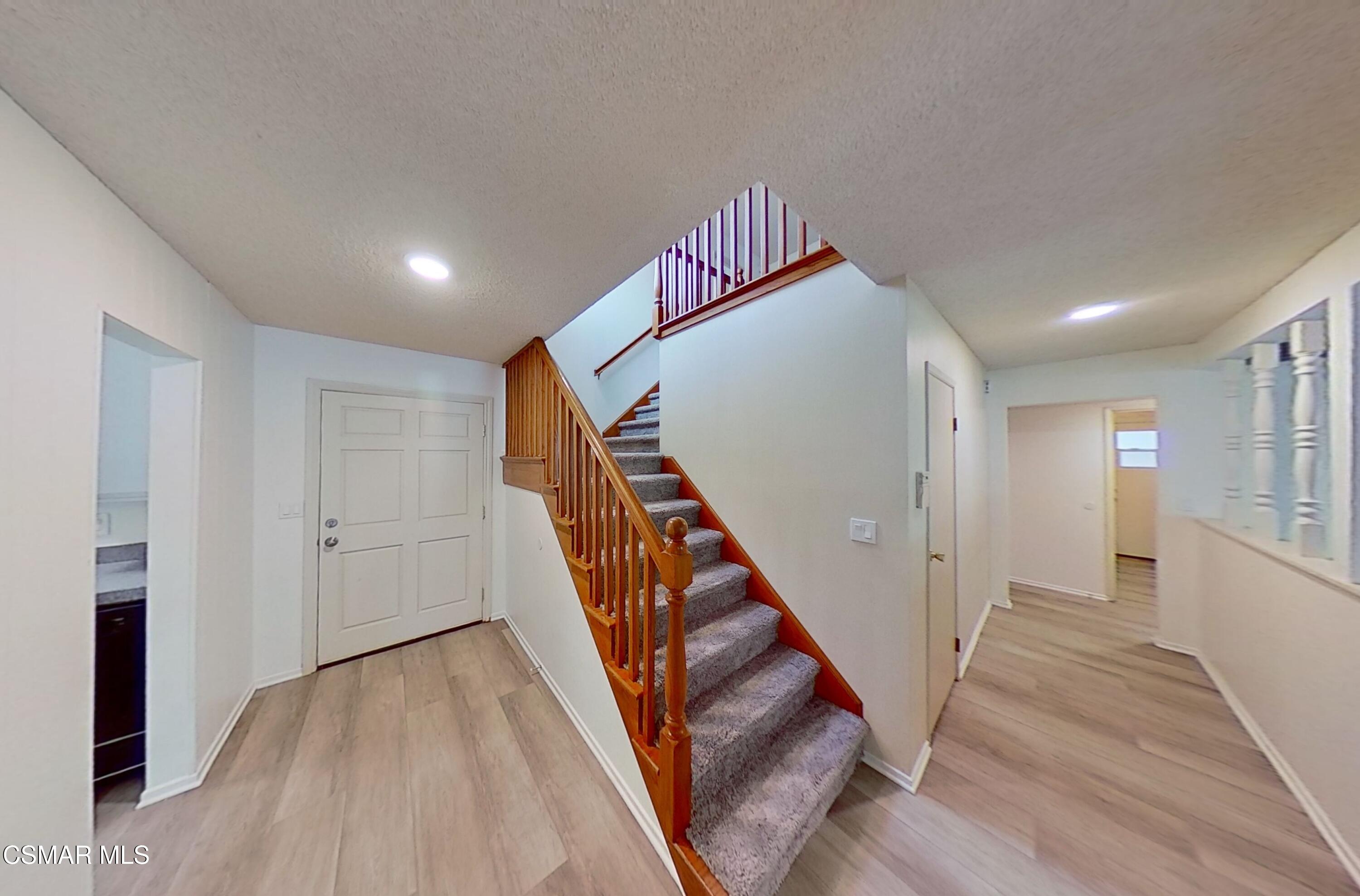 577 Appleton Road Simi Valley, CA 93065 - Photo 3 of 31 a view of a hallway with stairs and wooden floor