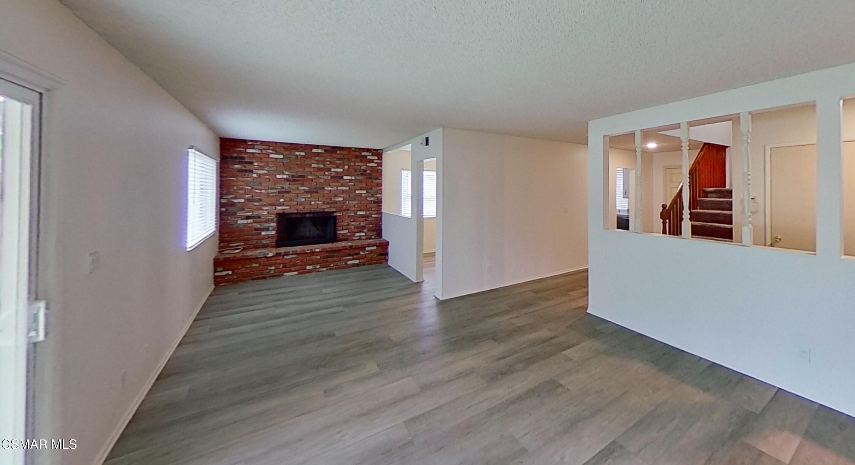 577 Appleton Road Simi Valley, CA 93065 - Photo 4 of 31 wooden floor in an empty room with a fireplace