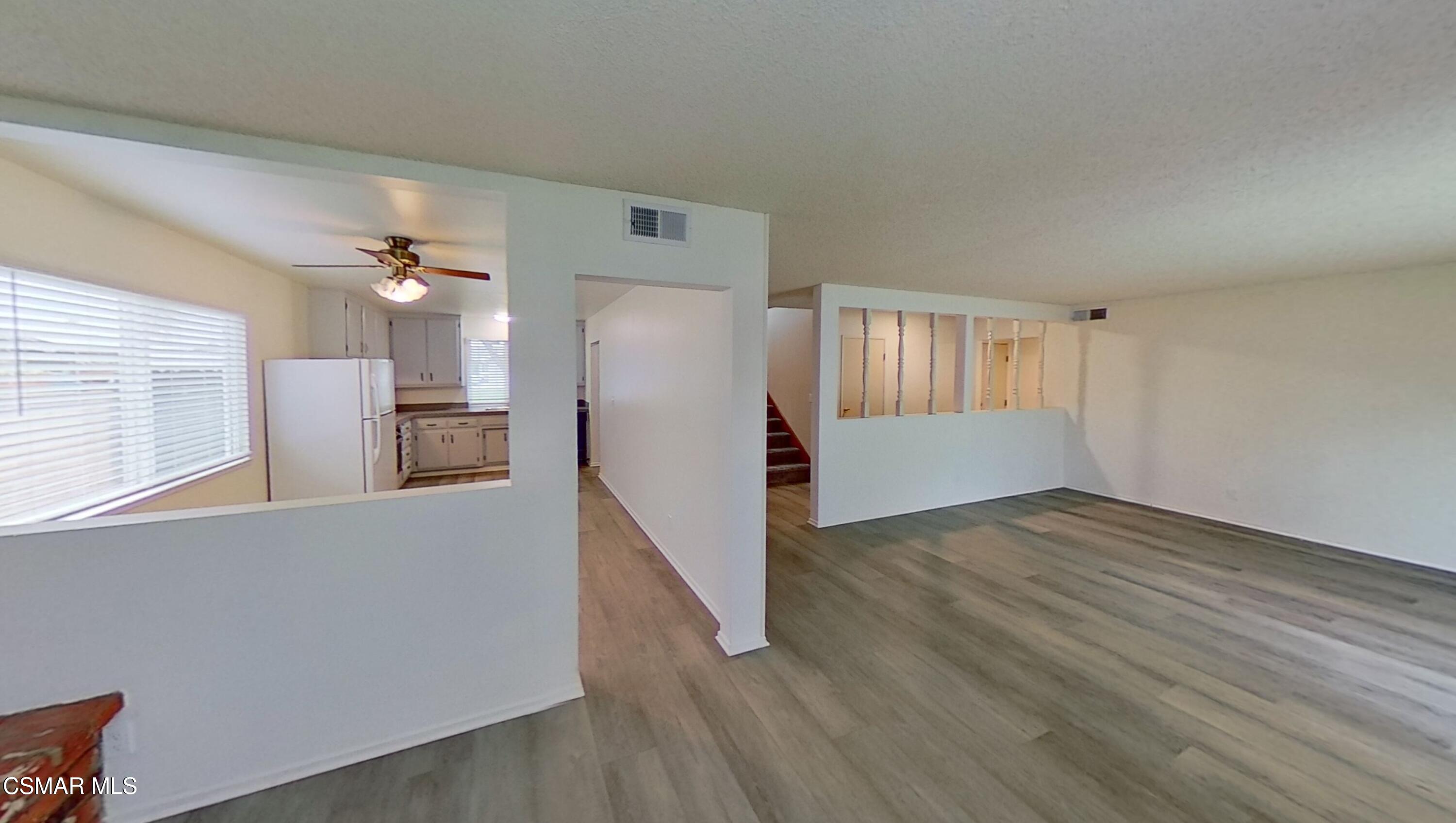 577 Appleton Road Simi Valley, CA 93065 - Photo 5 of 31 a view of a kitchen with wooden floor and a refrigerator