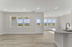 2760 River Meadow Spring Hope, NC 27882 - Photo 9 of 42 a view of an empty room with glass door and wooden floor