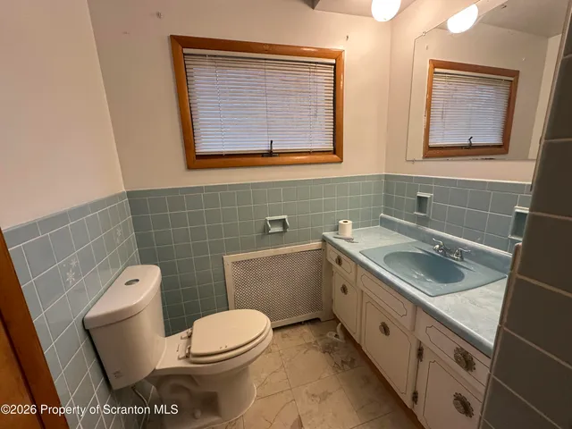 a bathroom with a shower and a sink
