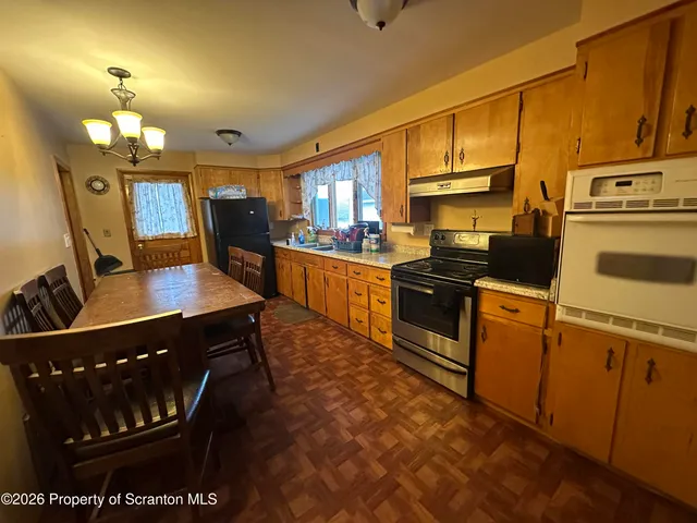 a kitchen with stainless steel appliances a stove a sink dishwasher and cabinets