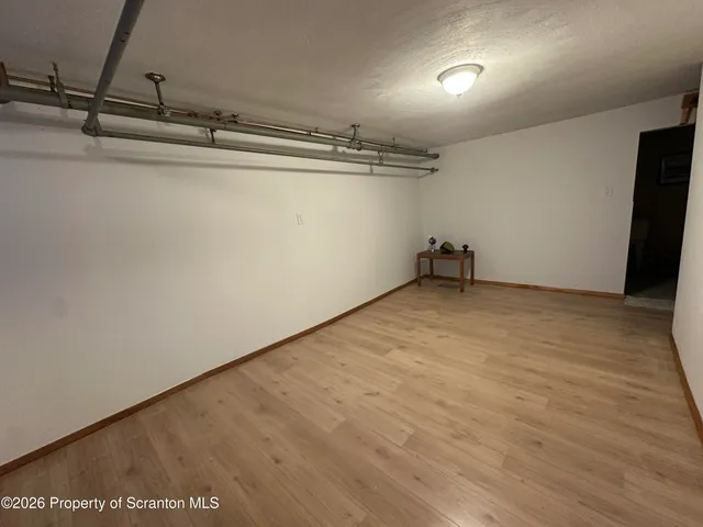 a view of a room with wooden floor