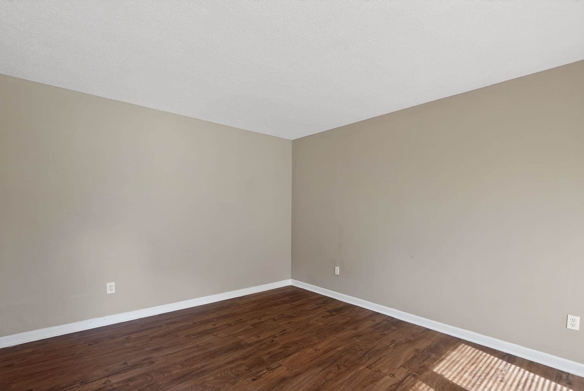 4587 Appleville Street Memphis, TN 38109 - Photo 12 of 34 Spare room with dark wood finished floors and baseboards