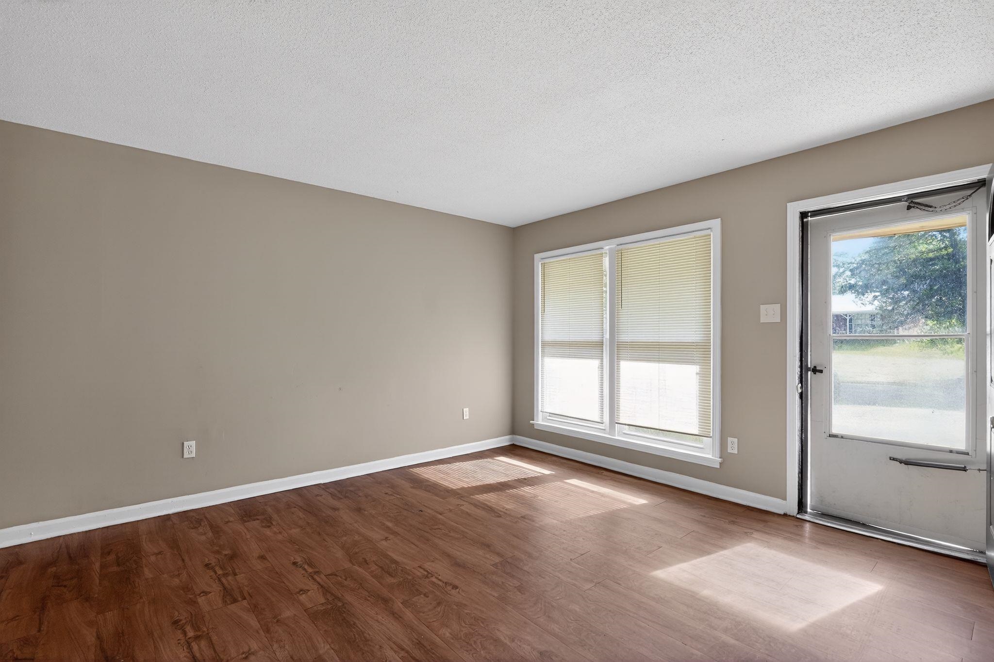 4587 Appleville Street Memphis, TN 38109 - Photo 14 of 34 Unfurnished room featuring dark wood finished floors and a textured ceiling