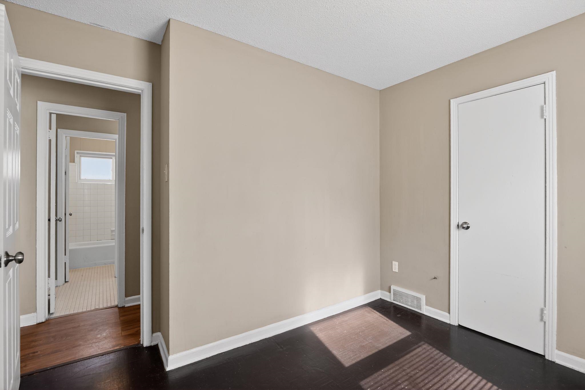 4587 Appleville Street Memphis, TN 38109 - Photo 20 of 34 Empty room featuring a textured ceiling and dark wood finished floors