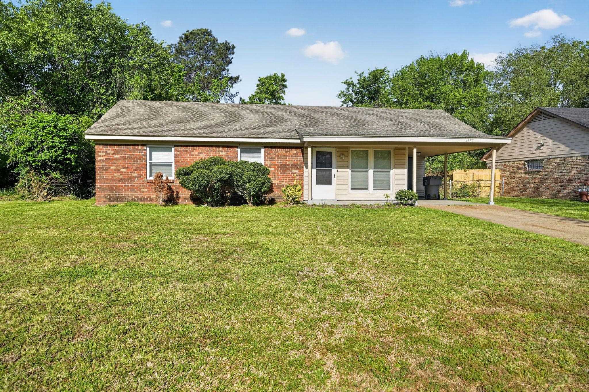 4587 Appleville Street Memphis, TN 38109 - Photo 2 of 34 Ranch-style house featuring an attached carport, driveway, a front yard, brick siding, and covered porch