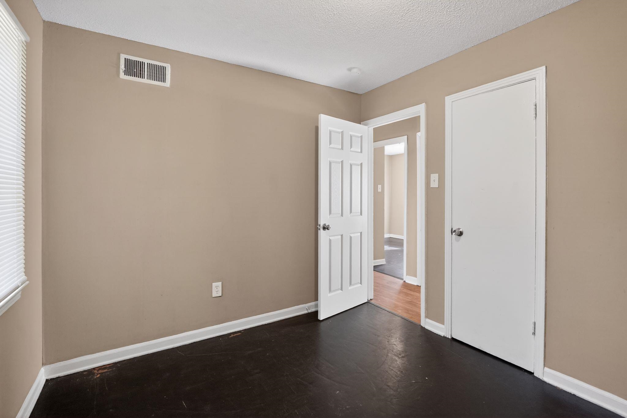 4587 Appleville Street Memphis, TN 38109 - Photo 21 of 34 Unfurnished bedroom with dark wood-style flooring and a textured ceiling
