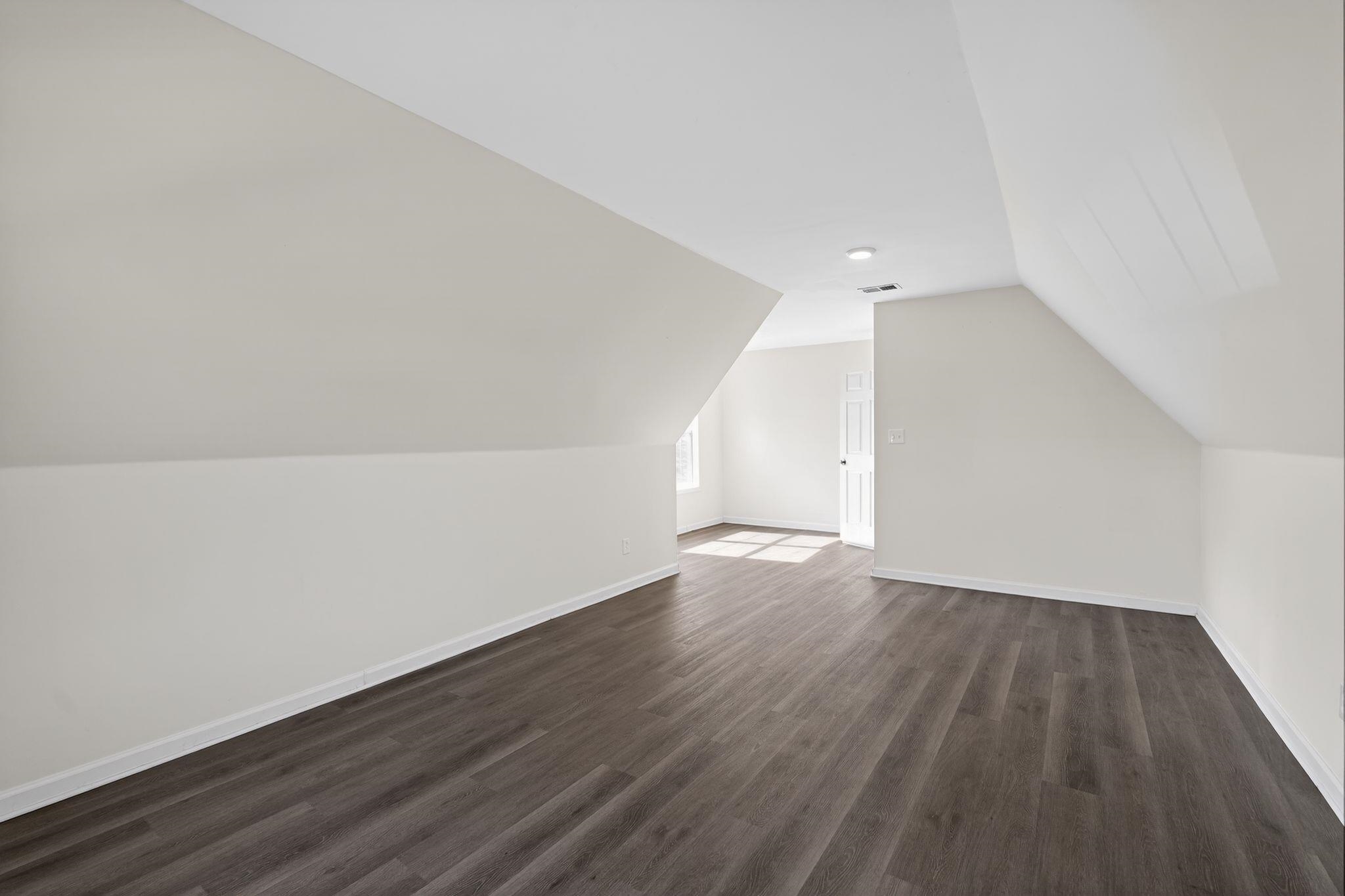 4587 Appleville Street Memphis, TN 38109 - Photo 25 of 34 Bonus room featuring baseboards and dark wood-type flooring