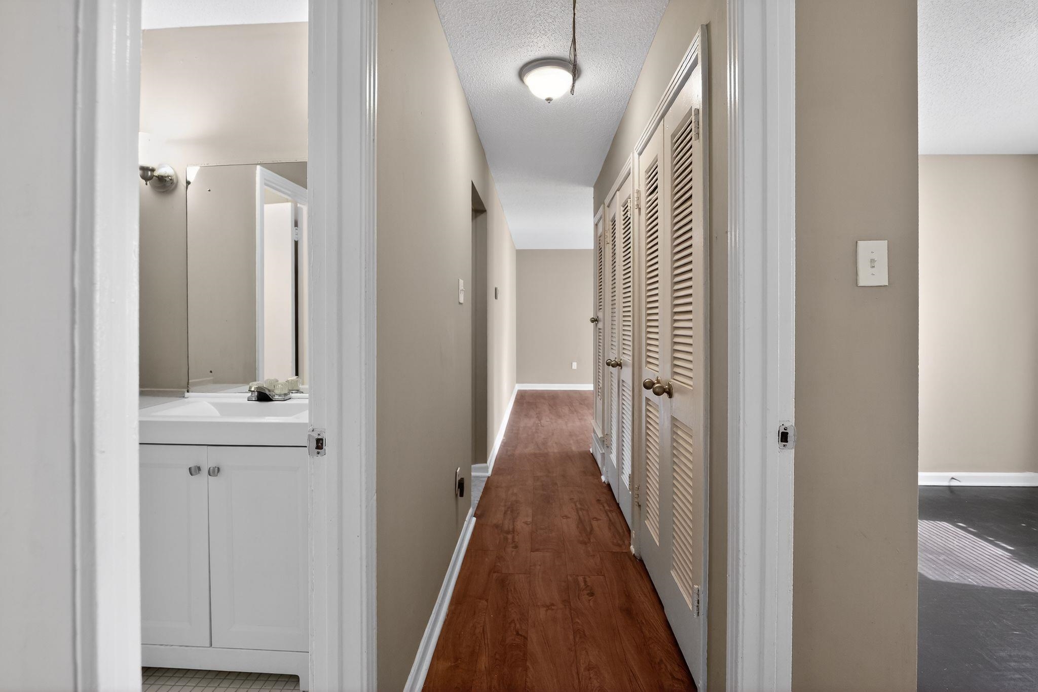 4587 Appleville Street Memphis, TN 38109 - Photo 26 of 34 Hallway with dark wood finished floors and a textured ceiling