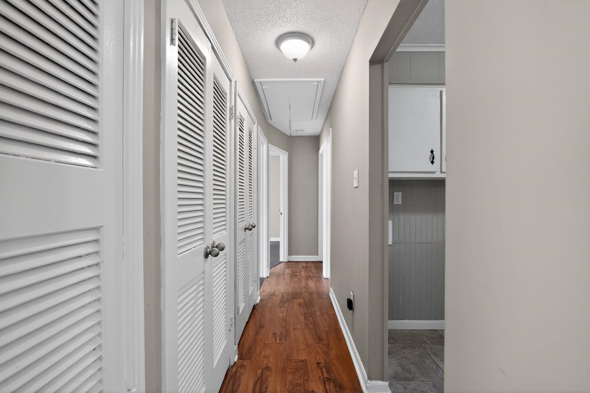 4587 Appleville Street Memphis, TN 38109 - Photo 27 of 34 Corridor featuring a textured ceiling and dark wood-style flooring
