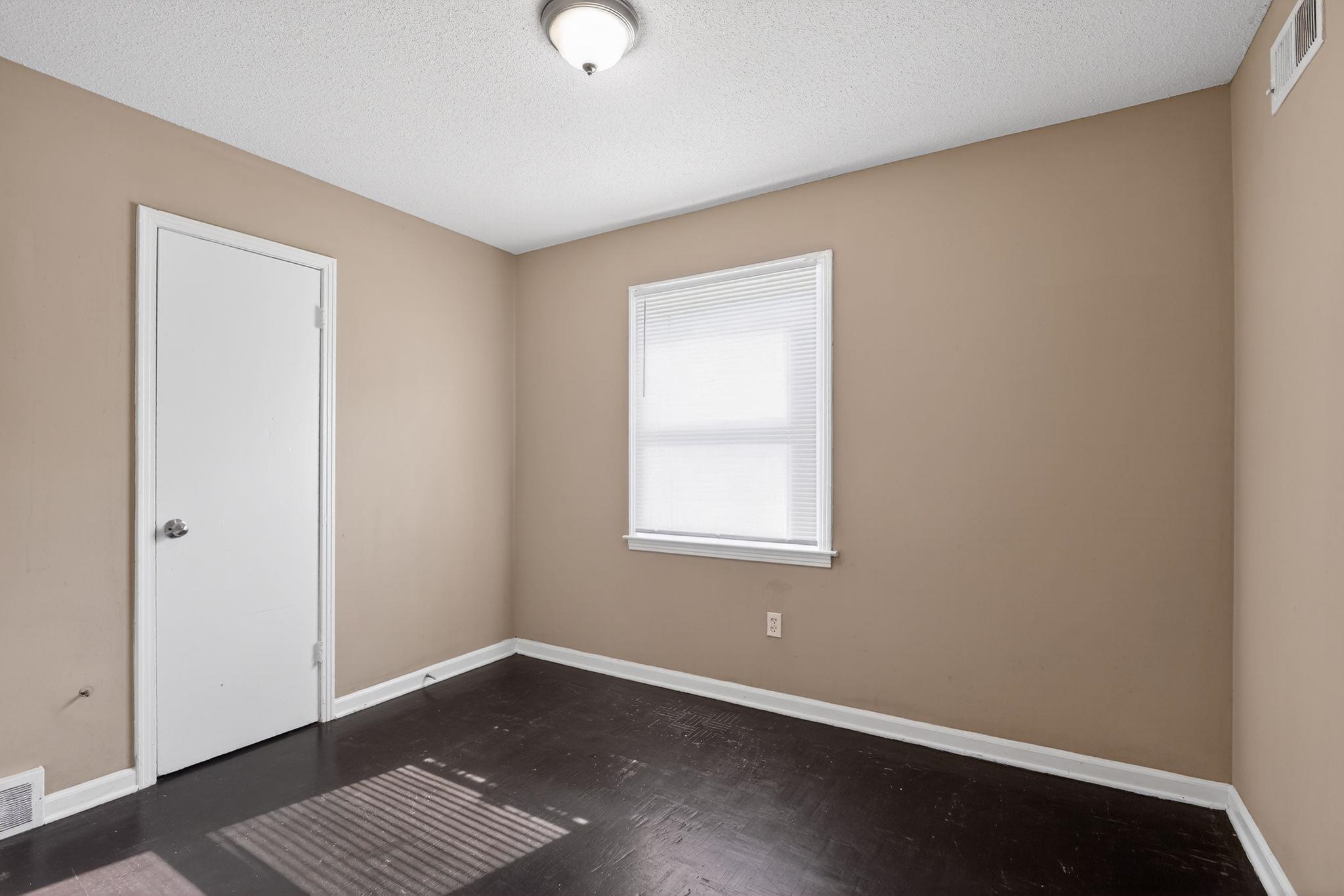 4587 Appleville Street Memphis, TN 38109 - Photo 7 of 34 Empty room featuring baseboards and a textured ceiling