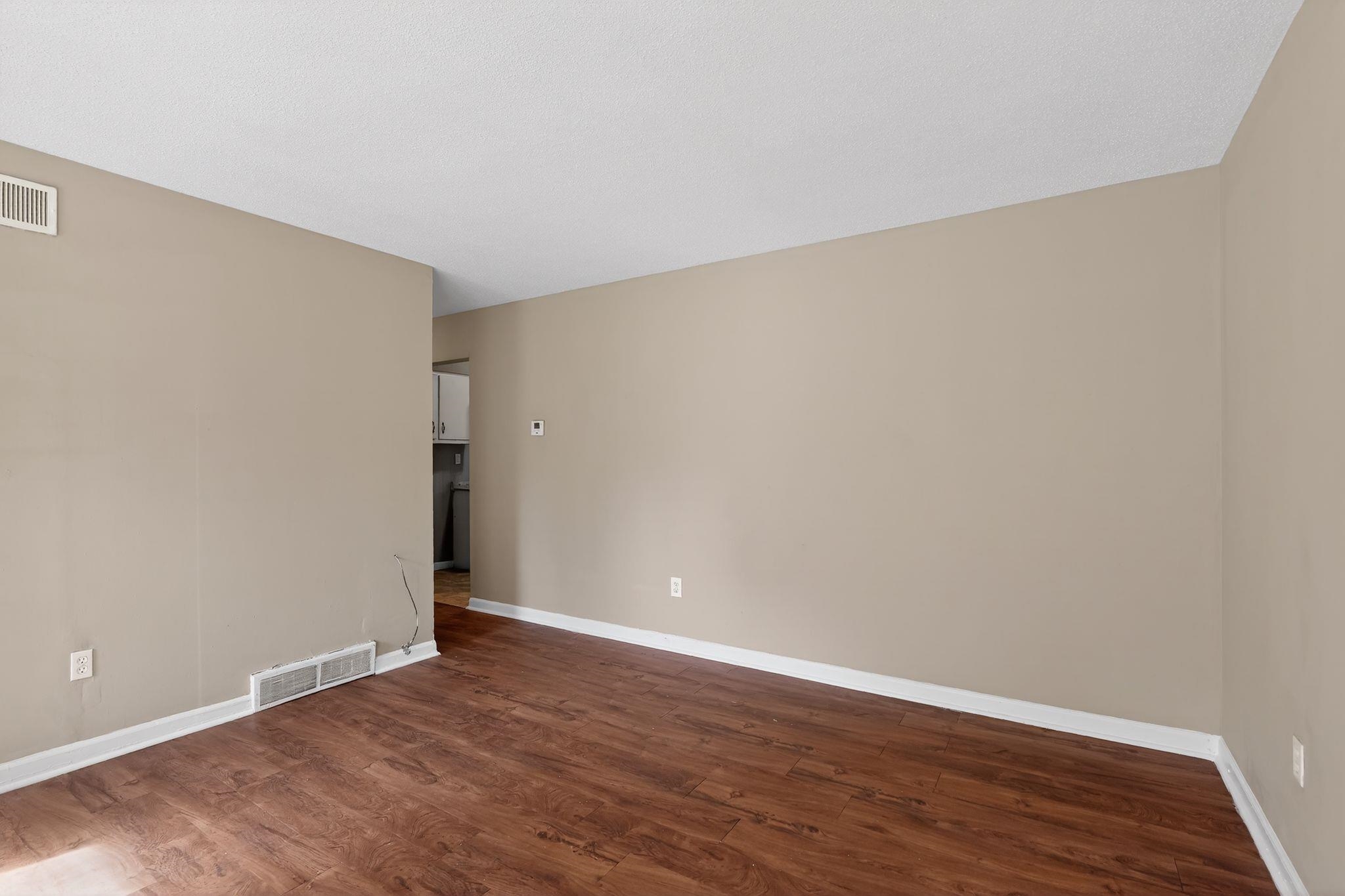 4587 Appleville Street Memphis, TN 38109 - Photo 10 of 34 Spare room with dark wood-style flooring and baseboards