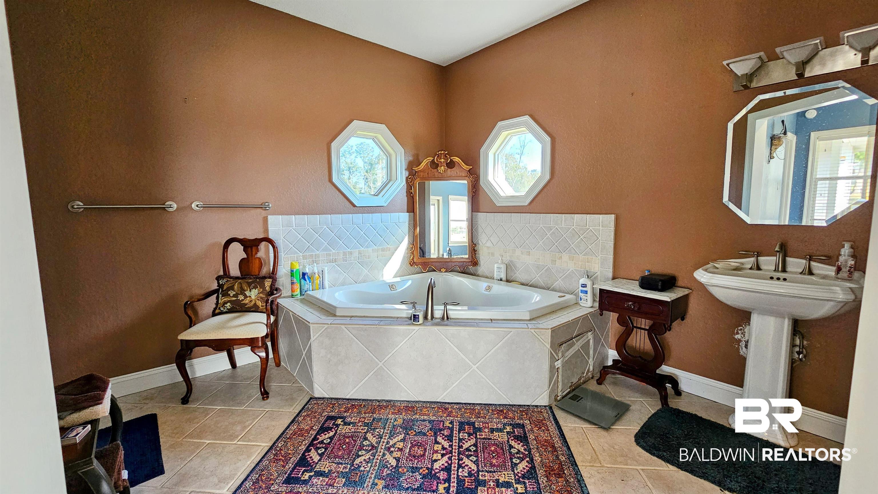 9275 Crawford Road Elberta, AL 36530 - Photo 14 of 28 Full bathroom with a garden tub and light tile patterned floors