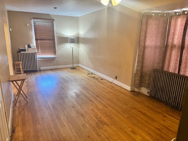 wooden floor in an empty room with a window