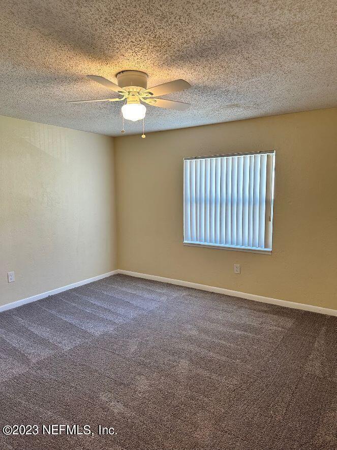 58 Masters Drive, Unit B St. Augustine, FL 32084 - Photo 8 of 10 an empty room with windows and fan