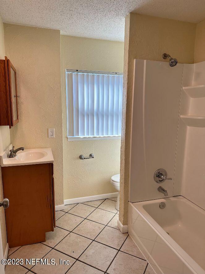 58 Masters Drive, Unit B St. Augustine, FL 32084 - Photo 9 of 10 a bathroom with a tub a sink and a shower