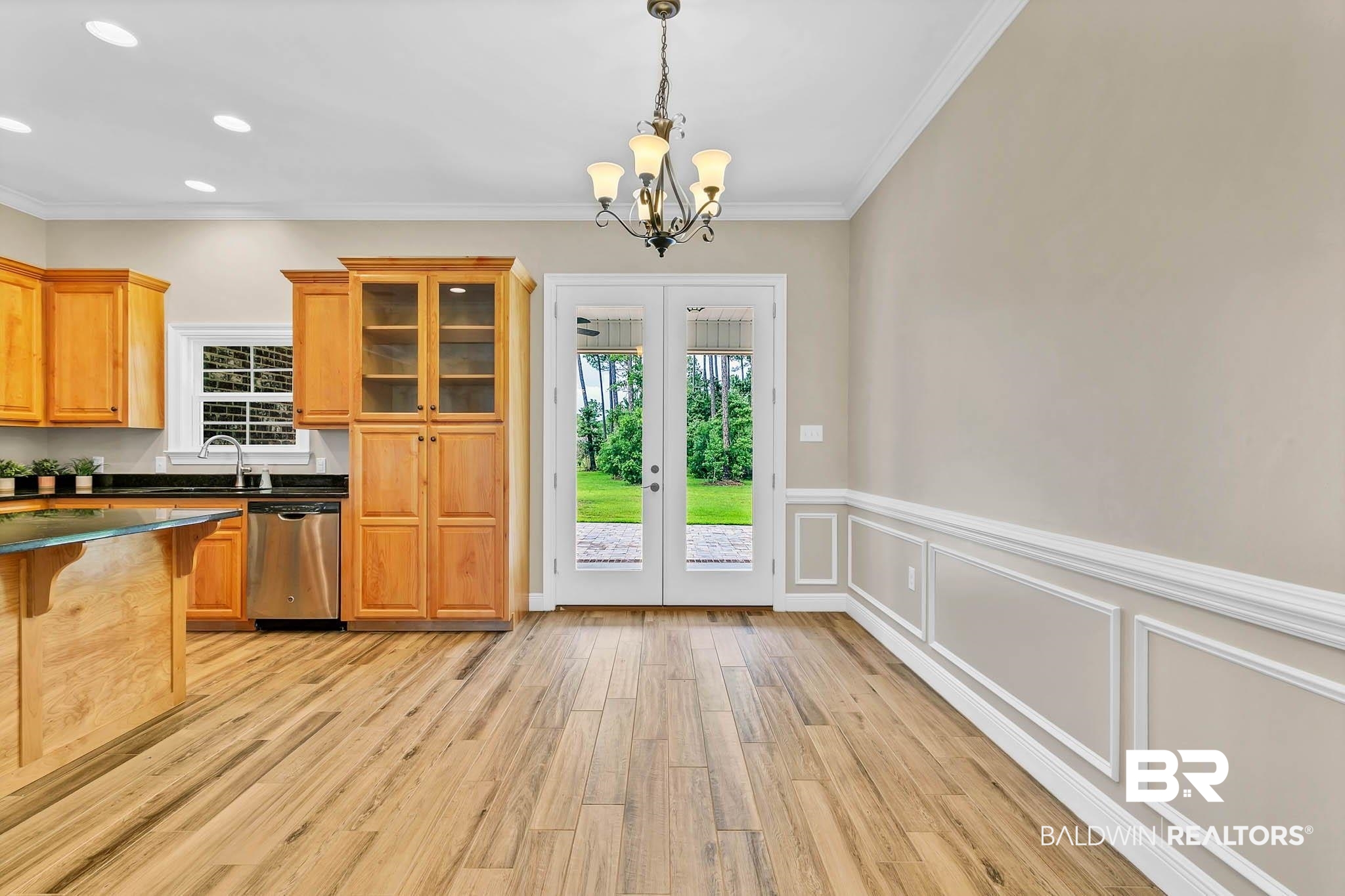 8145 Bay View Drive Foley, AL 36535 - Photo 17 of 81 Kitchen with dishwasher, french doors, dark countertops, light wood-style floors, and a chandelier