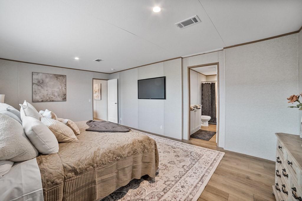 2013 Buffet Way Poolville, TX 76487 - Photo 13 of 37 a bedroom with a bed and a flat screen tv