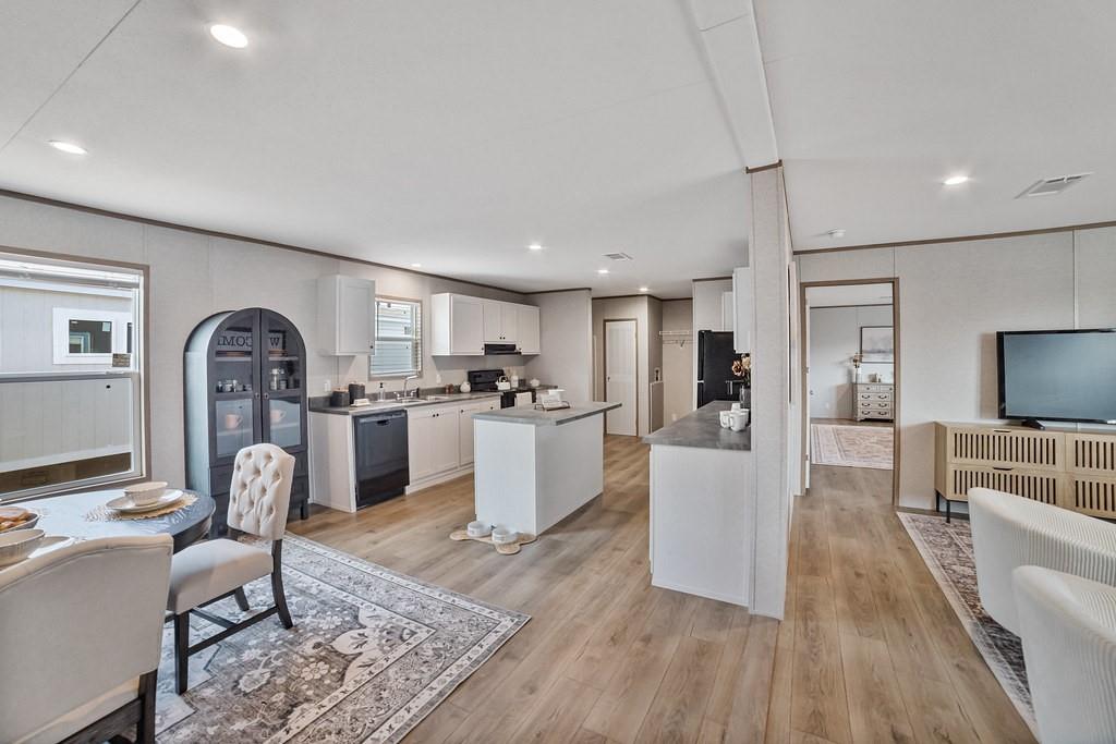 2013 Buffet Way Poolville, TX 76487 - Photo 9 of 37 a living room with furniture a flat screen tv and a refrigerator