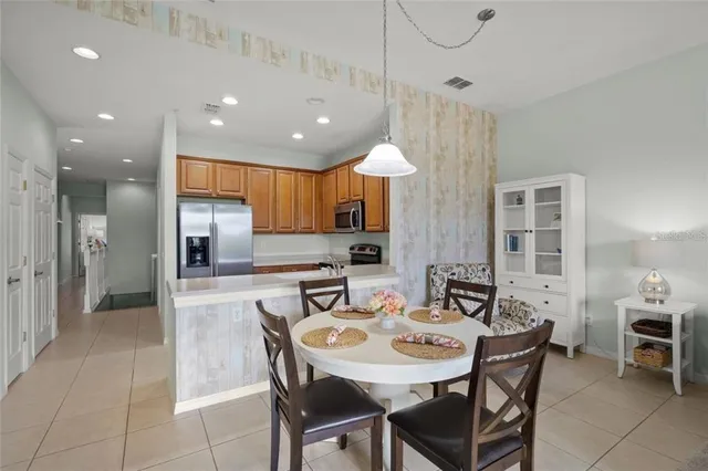a kitchen with kitchen island a dining table and chairs