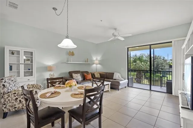 a view of a dining room with furniture large windows and wooden floor