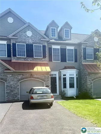 a car parked in front of a brick house