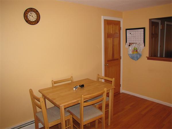121 Cambridge Road, Unit 3 Woburn, MA 01801 - Photo 11 of 21 a view of a dining room with a table and a chair