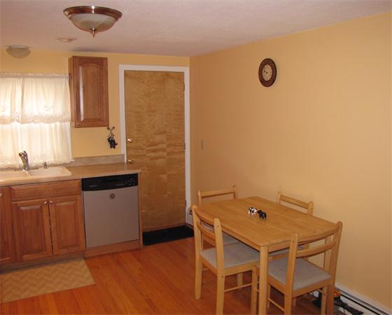 121 Cambridge Road, Unit 3 Woburn, MA 01801 - Photo 12 of 21 a kitchen with a sink cabinets and wooden floor