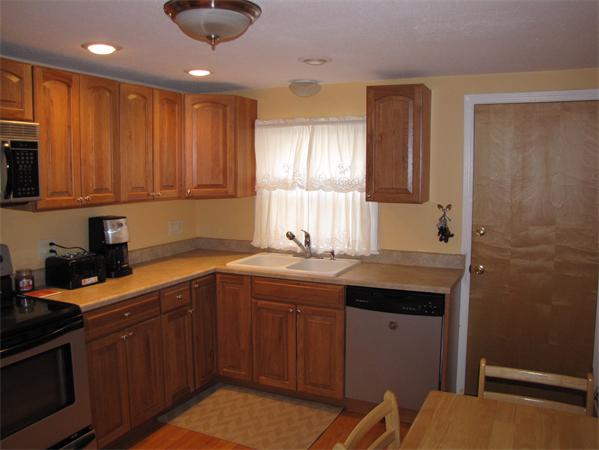 121 Cambridge Road, Unit 3 Woburn, MA 01801 - Photo 13 of 21 a kitchen with stainless steel appliances granite countertop a sink stove and cabinets