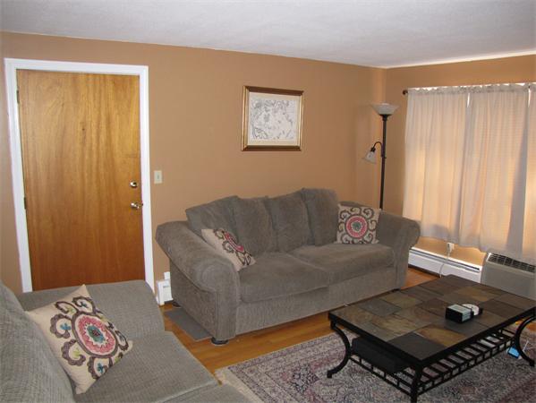 121 Cambridge Road, Unit 3 Woburn, MA 01801 - Photo 4 of 21 a living room with a couch and a window