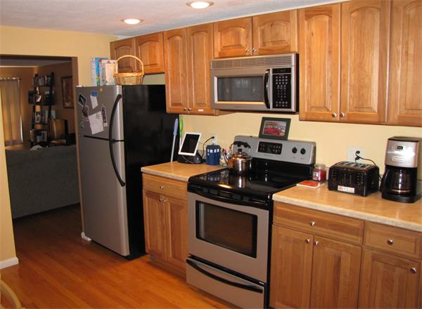121 Cambridge Road, Unit 3 Woburn, MA 01801 - Photo 10 of 21 a kitchen with stainless steel appliances granite countertop a refrigerator stove and sink