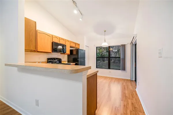 a kitchen that has a sink stainless steel appliances a counter top space and cabinets