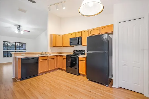 a kitchen with a sink cabinets and a window