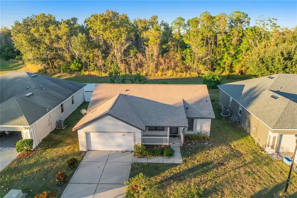 an aerial view of a house with a yard