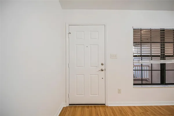 a view of a livingroom with wooden floor and a ceiling fan