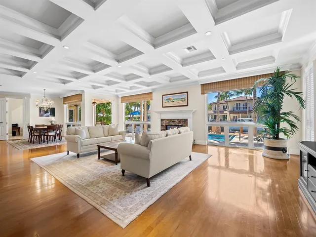a living room with patio furniture and a floor to ceiling window