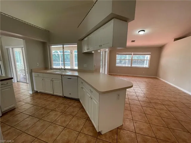 a kitchen with stainless steel appliances a sink a stove a microwave a counter top and cabinets