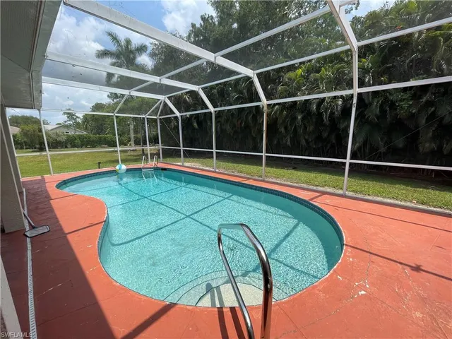 a view of a swimming pool with an outdoor seating