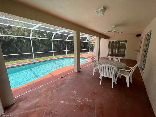 a view of a chair and tables in the patio